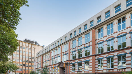 Photo of the old building and the skyscraper on Sonnenstrasse across the parking lot. __ <br>View of the old building and the skyscraper on Sonnenstrasse across the parking lot.