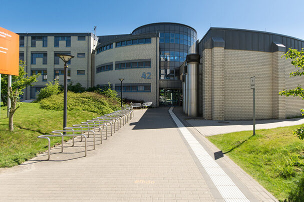 Front view of the building at Emil-Figge-Strasse 42, looking towards the main entrance.