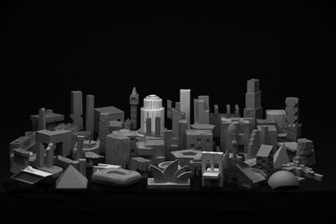 Black and white general view of the filigree concrete sculptures as a result of the "miniature architecture" exercise. The composition of the sculptures is reminiscent of a city. The individual sculptures depict buildings and landmarks.