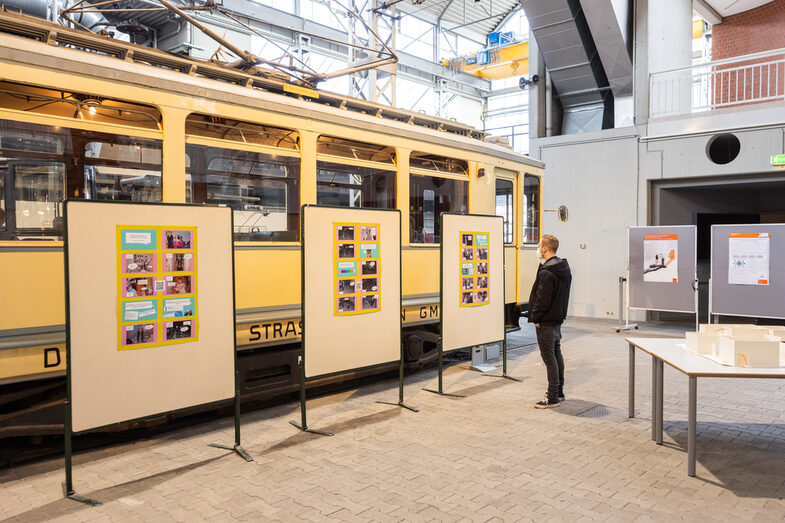 A participant looks at posters in the exhibition.