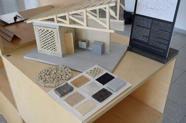 Detailed view of a model with various material samples in the foreground.