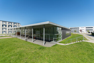 Photo of the KostBar canteen building, other buildings in the background.