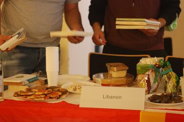 Eating on a decorated table at the Lebanon cultural stand