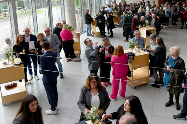 View into the foyer of the faculty with the graduates and their family and friends at the champagne reception and buffet after the event.