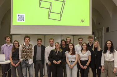 Gewinner des Architects Collective Student Award for Healthcare Architecture auf der Bühne vor einer Leinwand.