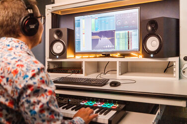 A man does creative sound design at the audio workstation.<br><br>