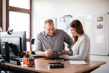 Photo of a trainee and her practical instructor at work.