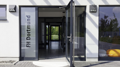 Photo of the open entrance door to the Emil-Figge-Straße 38 building at Fachhochschule Dortmund - University of Applied Sciences and Arts.