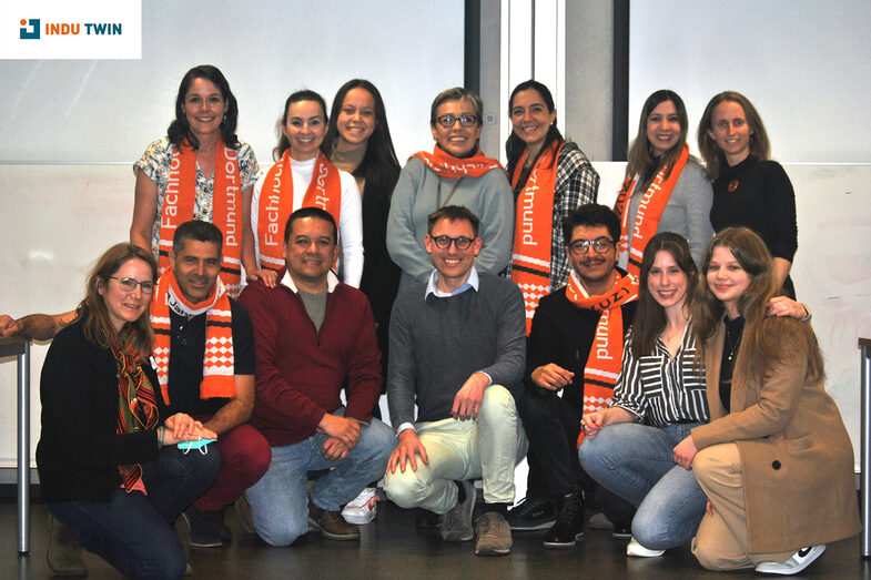 Group picture of the InduTwin Consortium. Several people are wearing the orange scarf of Fachhochschule Dortmund.