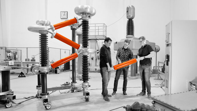 Three students work in the laboratory for high-voltage technology at Fachhochschule Dortmund.