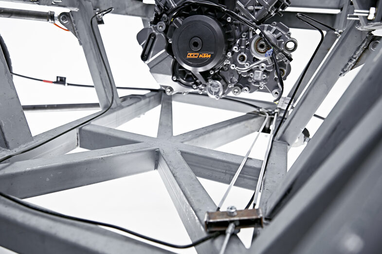 Close-up of the chassis, the handbrake cables and the KTM engine