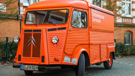 The orange Citroen HY is parked in front of the FH main building on Sonnenstrasse.