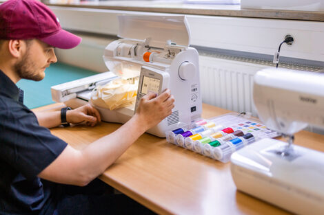 Photo of a student operating a sewing machine.