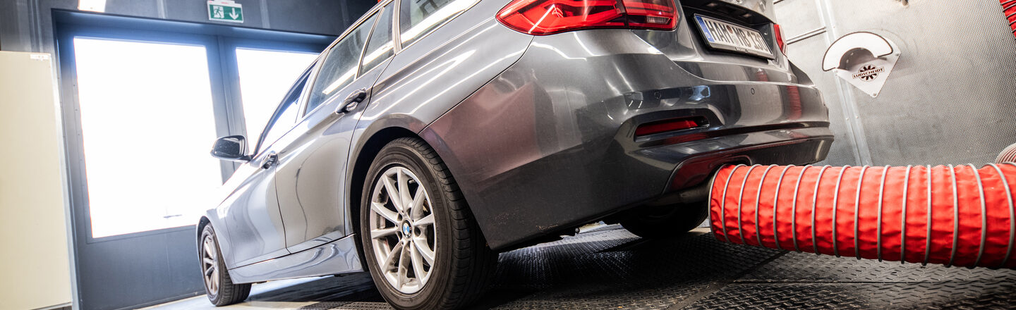 Photo of a vehicle with exhaust extraction on the chassis dynamometer.