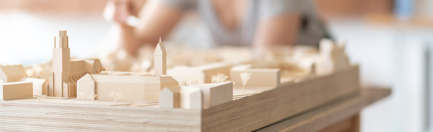 Close-up of an urban planning model with a student in the model making workshop<br>in the Faculty of Architecture