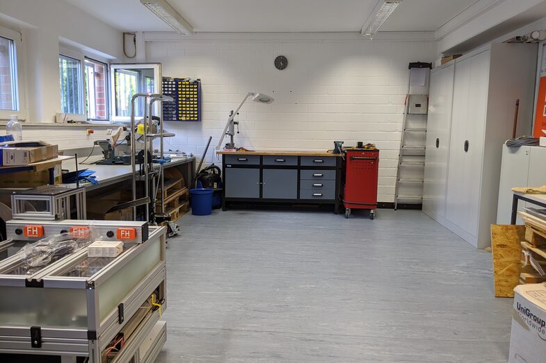 Workshop space with cupboards, shelves and workbenches