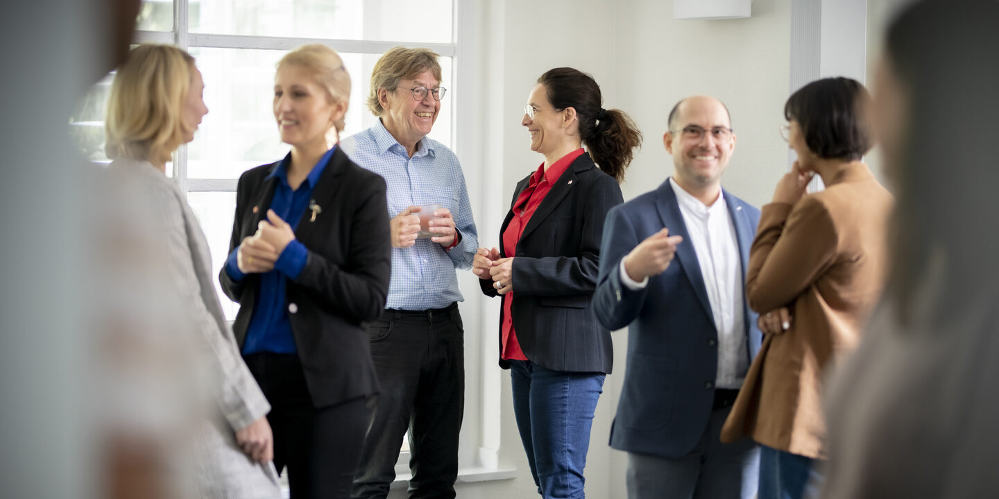 Photo of several people talking.