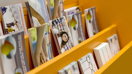 Photo of various leaflets, postcards and brochures at the service counter in the library__Photo of various leaflets, postcards and brochures at the service counter in the library