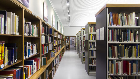 Photo of rows of bookshelves in the library__Photo of library book shelves