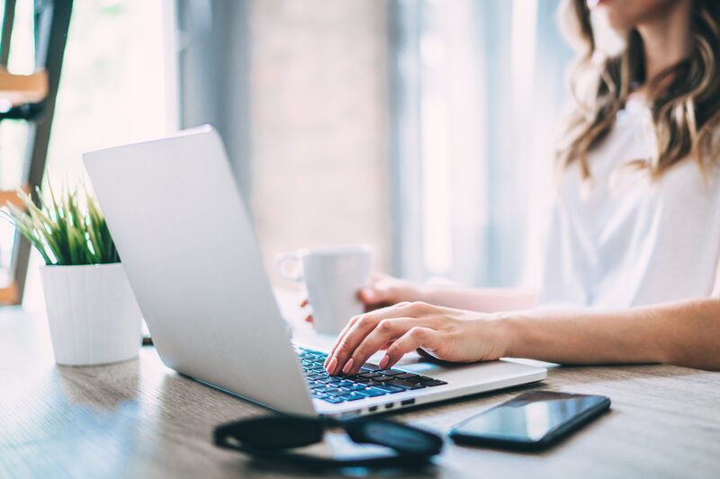 Cropped shot of young female freelancer working at home using her laptop. Student girl preparing to her final exam. Distant work and education in comfortable conditions concept.