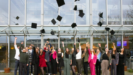 The graduates let their hats fly outside the Faculty of Architecture.
