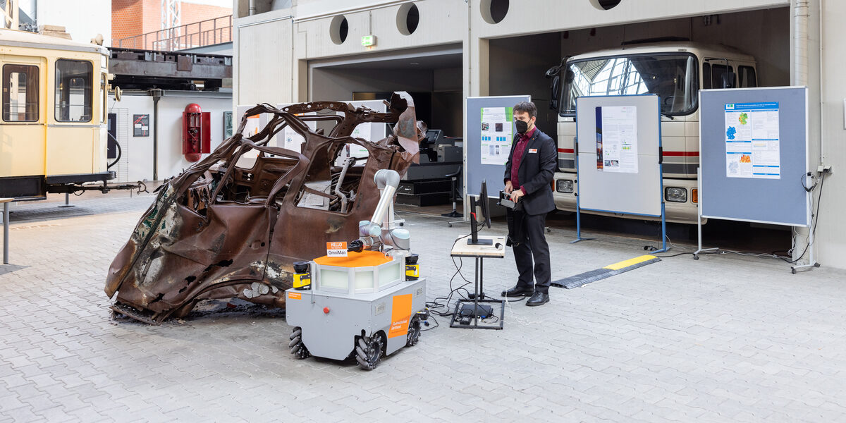 Doctoral student operates OmniMan an Omnidirectional mobile manipulator (robot).