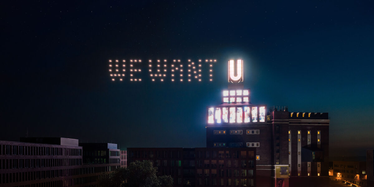 Next to the Dortmunder U, illuminated drones make the words "we want" appear.