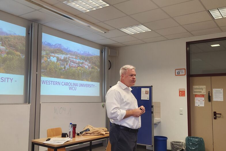 Prof. Alvin Malesky gives a lecture and stands in front of the whiteboard