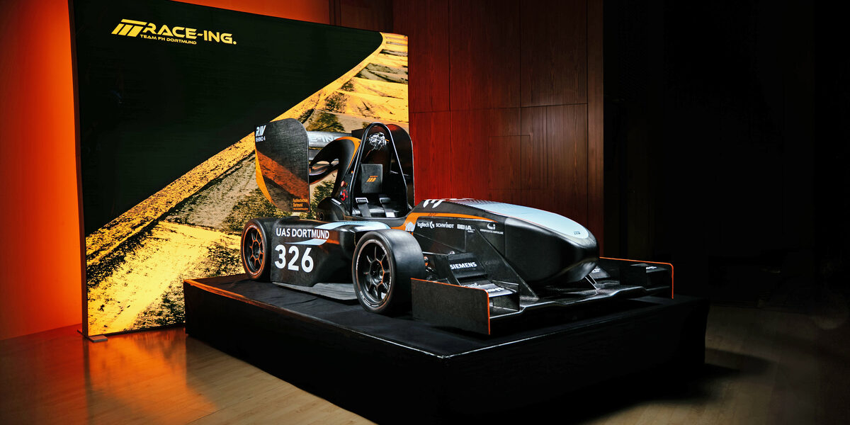 The Fachhochschule Dortmund racing car stands on a podium
