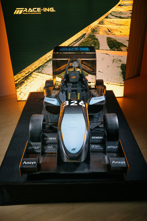 The Fachhochschule Dortmund racing car stands on a podium