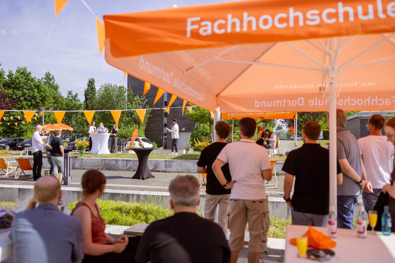 Doctoral students observe the program on stage