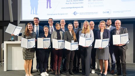 Group picture with several people, each holding a certificate in front of them.
