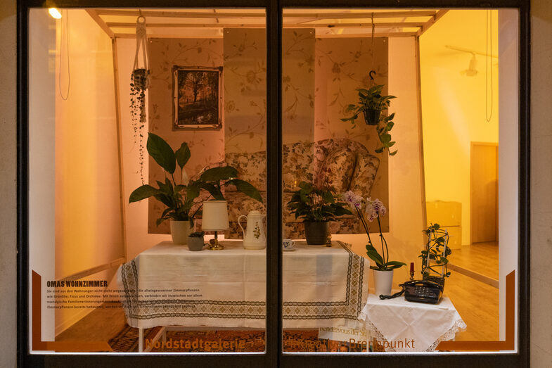 Illuminated window with artistic staging of a nostalgic living room.