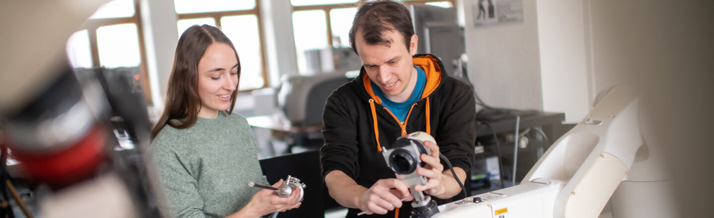 Photo of two people in a workshop in the Faculty of Information Technology.