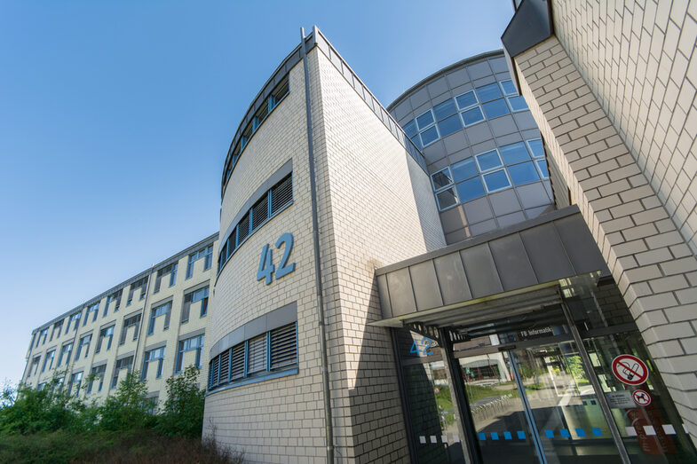 Foto der Einganstür und von Teilen des Gebäudes Emil-Figge-Straße 42 der Fachhochschule Dortmund.