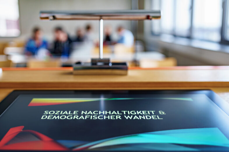 Photo of a desk with a screen entitled "Social sustainability and demographic change".