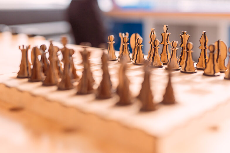 Photo of a close-up of a laser-cut wooden chessboard.